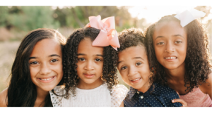 Four children and youth smiling