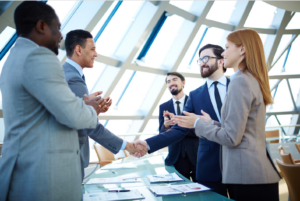 Business handshake at conference table